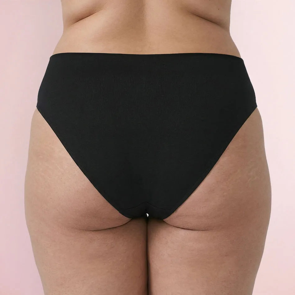 Woman wearing black Glow Fit Leakproof Underwear back view